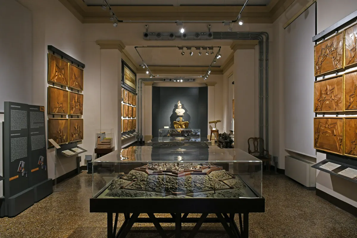 Galerie du musée de Palazzo Poggi, vitrines et maquettes sous des murs décorés
