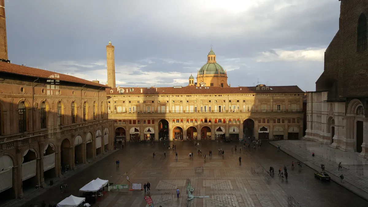 Piazza Maggiore baignée de lumière dorée, côté Palazzo dei Banchi