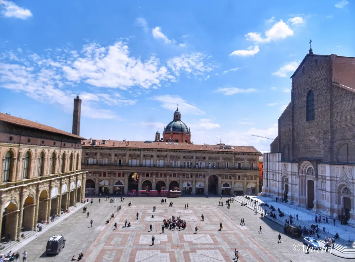 Piazza Maggiore sous un ciel bleu, avec la façade inachevée de San Petronio à droite